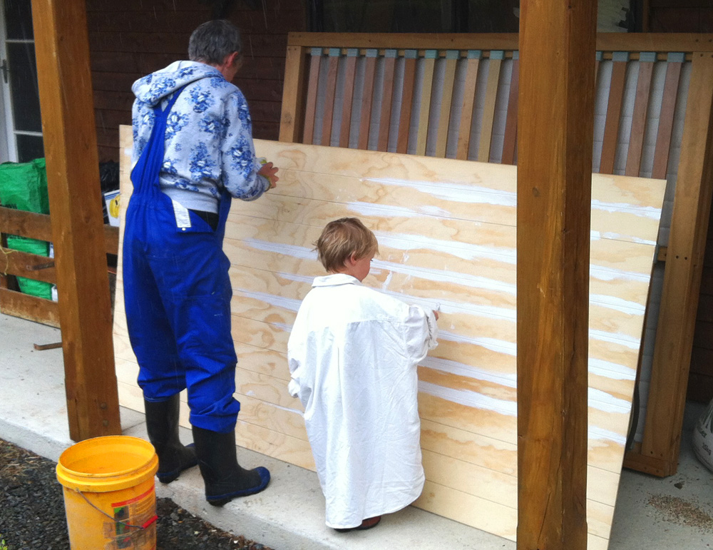 Painting the grooved plywood.